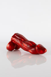 A product photo of a bull dildo lying down.