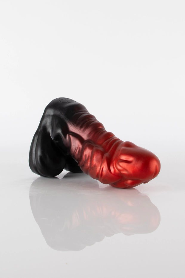 A product photo of a laid down dragon dildo.