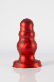 A photo taken of the back of a red bubble butt plug.