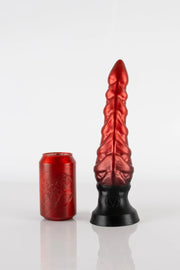 A medium-sized tentacle butt plug next to a can, going from red to black in colour.