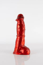 A photo of a red Pegasus dildo taken from the side.