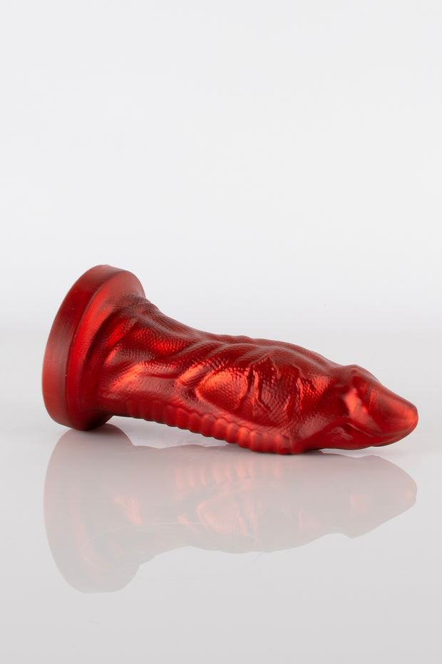 A product photo of a reptile dildo laying down.