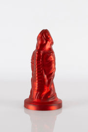 A product photo of a red reptile dildo showing off the toy's bulges.